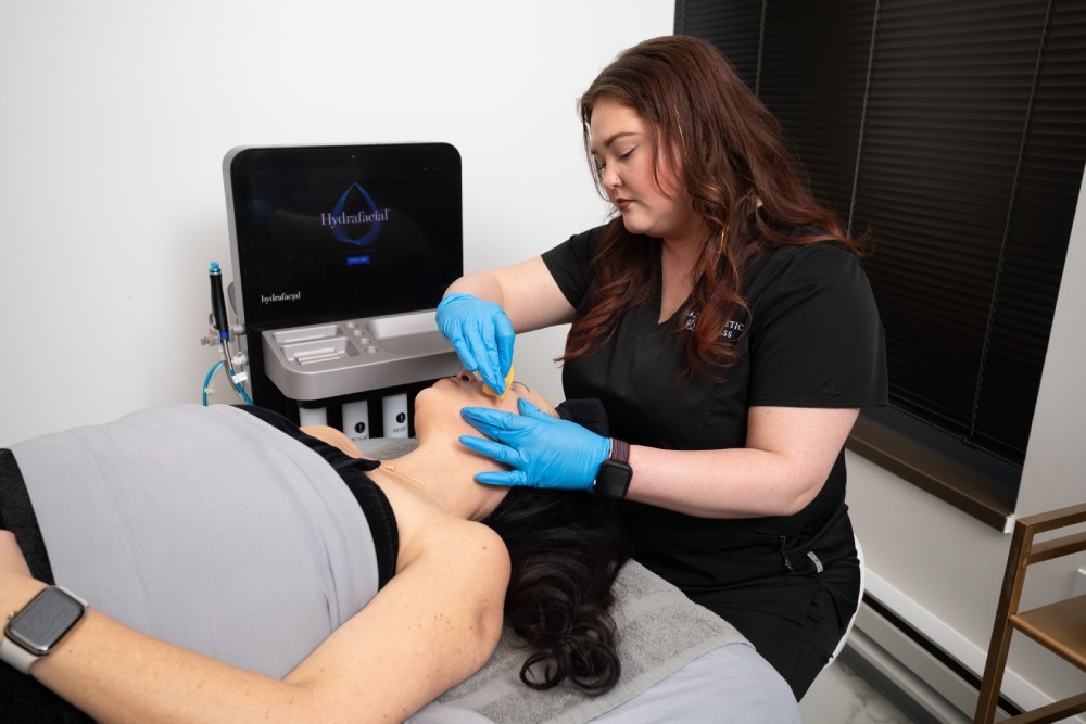 Med spa provider applying treatment to a client's face.