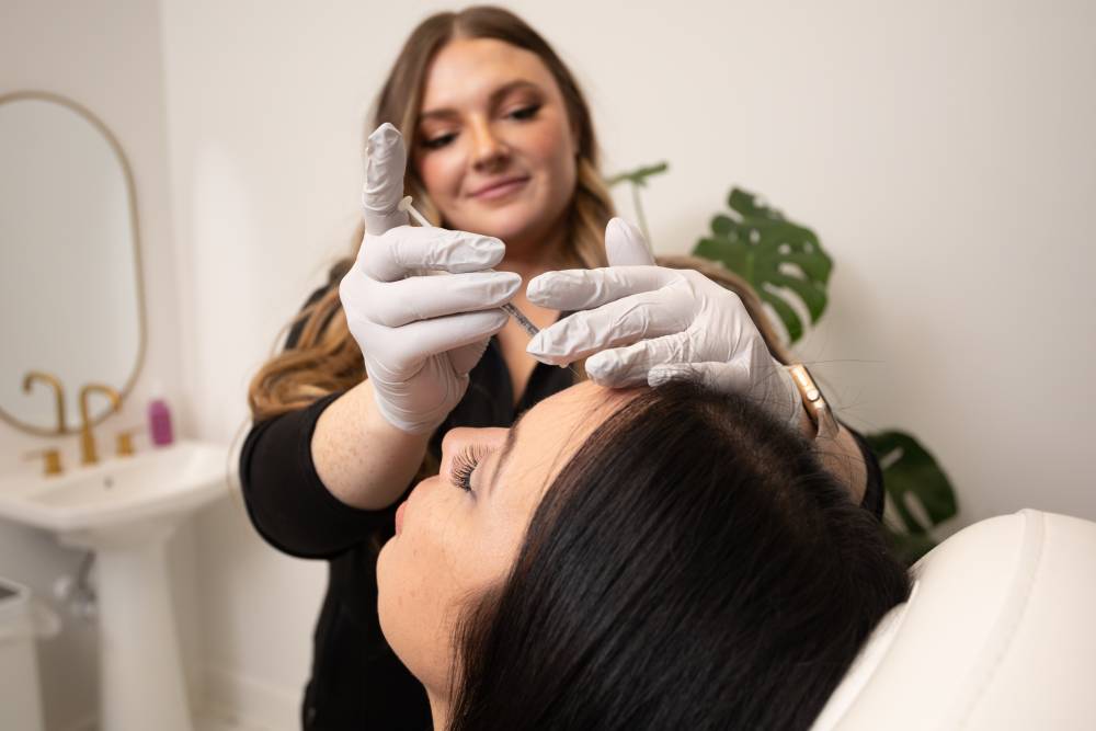 Medical professional performing a PDO Thread Lift on a patient's forehead.