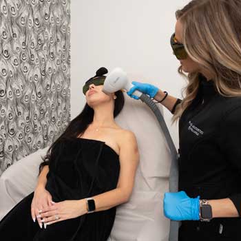 undergoing facial laser hair removal procedure.