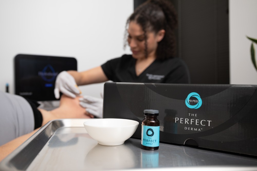 VI Peel product box and bottle displayed on a tray beside a facial treatment in progress